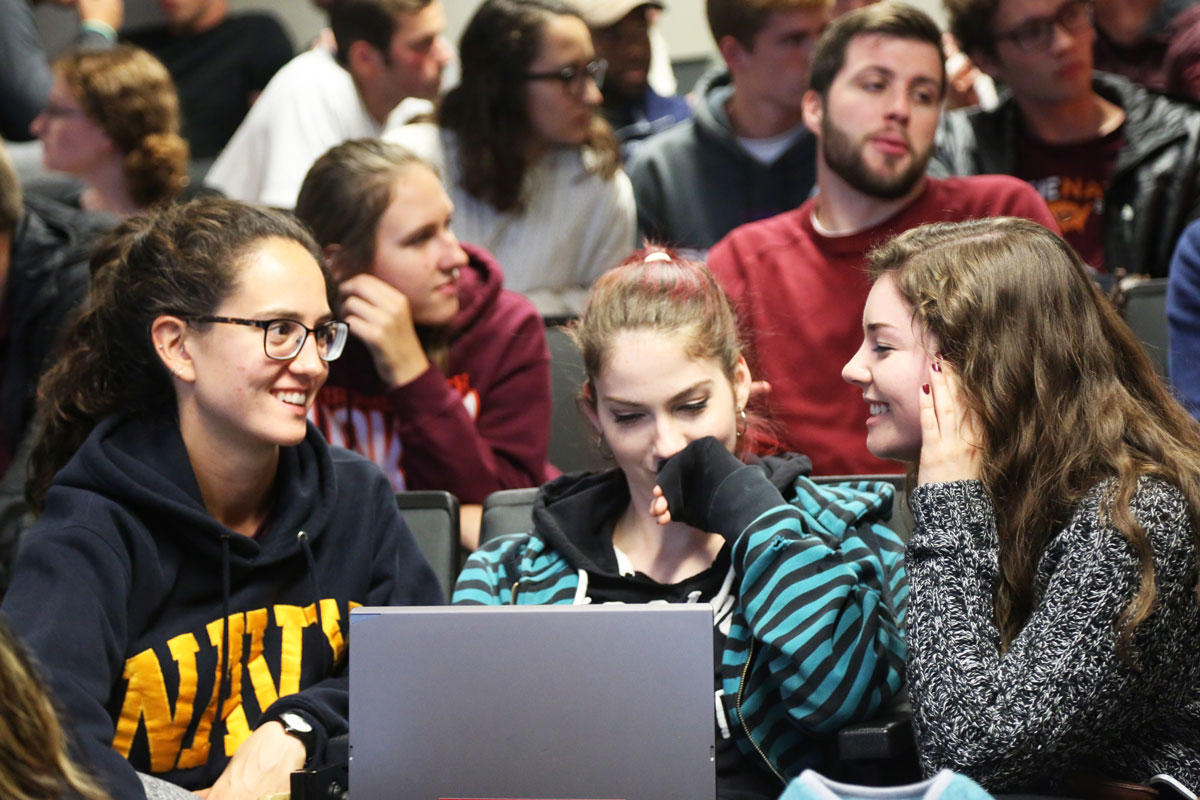 image of students at a laptop computer in a lecture hall